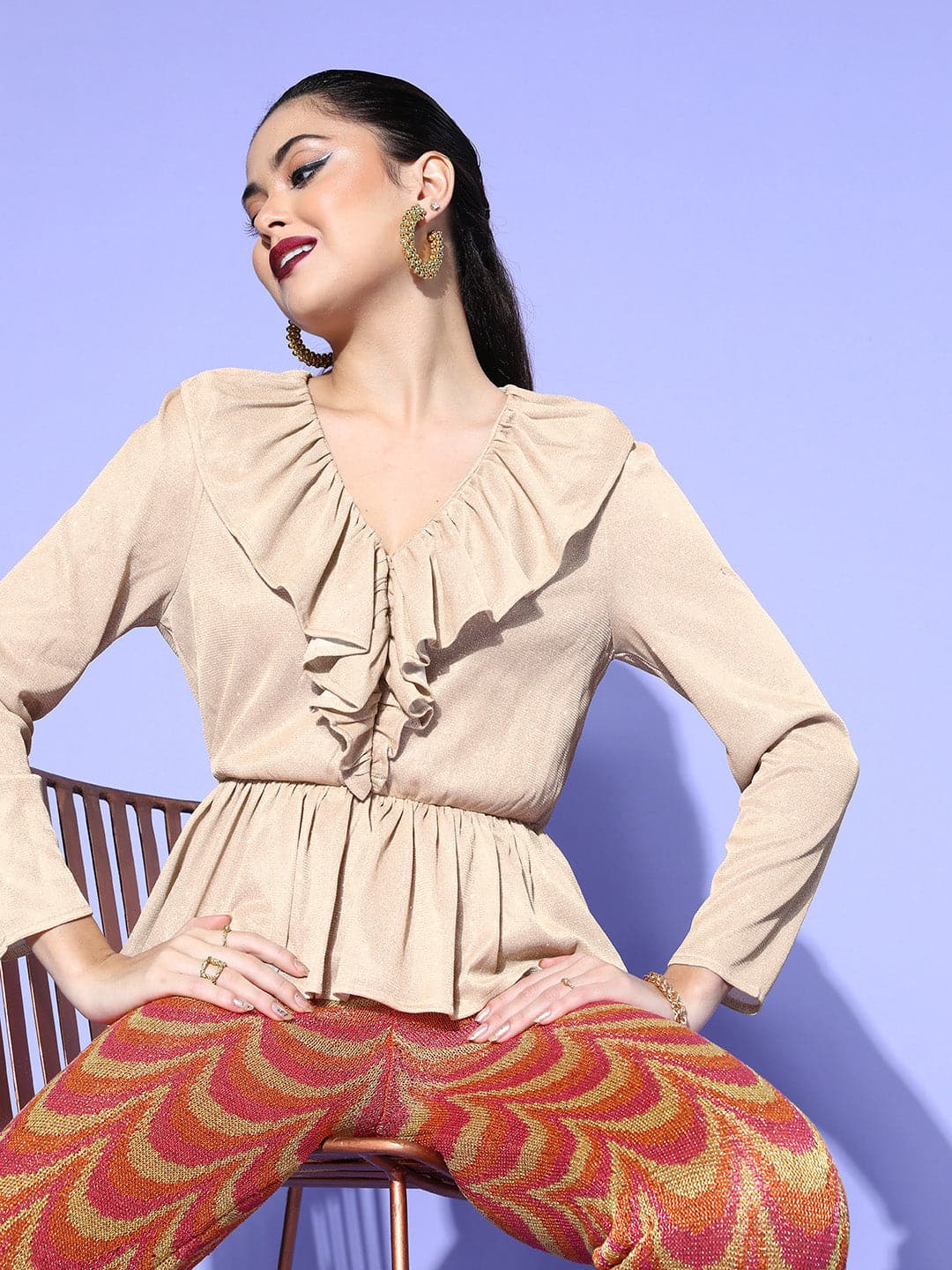 This Peplum Bell Sleeve Blouse with a ruffled hem takes Beige