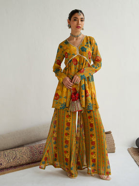 Mustard Floral Peplum Top With Bais Flared Sharara-Shae by SASSAFRAS