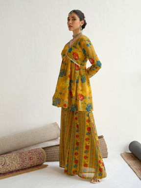 Mustard Floral Peplum Top With Bais Flared Sharara-Shae by SASSAFRAS